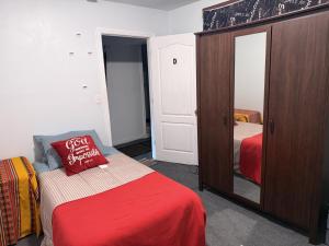 a bedroom with a bed and a dresser with a mirror at The paradise Retreats in Bonny Doon