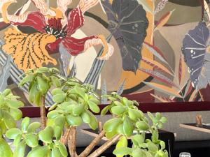 a plant in front of a wall with a painting at Gabriel Hotel Chinon in Chinon +43 photos