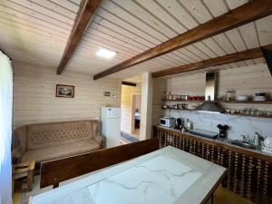 a kitchen with a couch and a table in a room at Наш котедж in Krivopolʼye