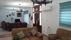 a living room with a couch and a table at منزل ومزرعه للايجار الشوبكً Farm for rent , Shoubak , Petra in Nijil