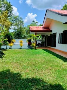 a house with a lawn in front of it at New Villa Senor Beruwala in Beruwala