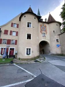 a large building with a clock on the side of it at 18 Steps to a Secret Tower in Porrentruy