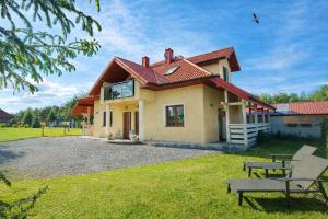 a small house with a red roof at Agroturystyka Serce Łysicy in Święta Katarzyna