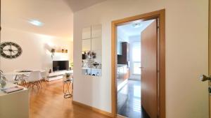 a living room with a door leading to a kitchen at Casa Silvana in Caniço