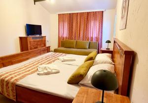 a bedroom with a bed with a chair and a couch at Къща за гости Арт Спектър in Bratsigovo