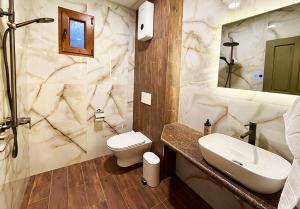 a bathroom with a sink and a toilet and a shower at Къща за гости Арт Спектър in Bratsigovo