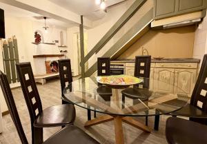 a dining room with a glass table and chairs at Къща за гости Арт Спектър in Bratsigovo +10 photos