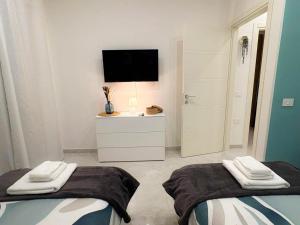 a living room with two beds and a television at Nicola's Apartments in Santa Maria La Carità