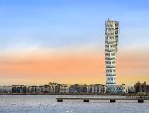 a tall building next to a large body of water at Cozy loft living in Malmö +6 photos