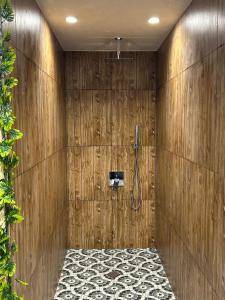 a bathroom with a shower in a wooden wall at Резиденция БАЛМОРА in Kalofer +23 photos
