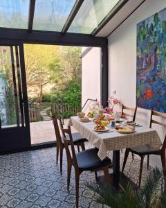 a dining room with a table with food on it at Le Huis Clos in Amboise +24 photos