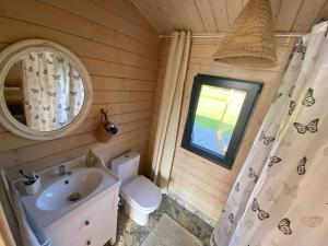 a bathroom with a sink and a toilet and a window at Ezermāja "Spārītes" in Geraņimova