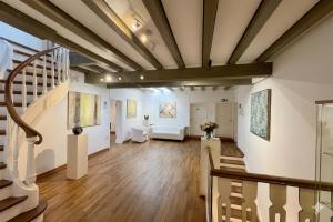an art gallery with white walls and wooden ceilings at Rhein River Guesthouse - direkt am Rhein in Leverkusen