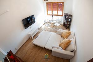a living room with a white couch and a table at Argent House Orbetello in Orbetello
