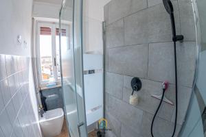 a bathroom with a shower with a glass door at Argent House Orbetello in Orbetello