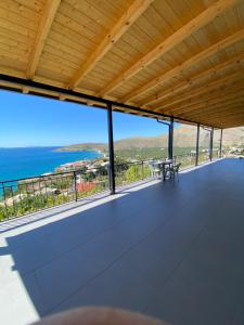 a view of the ocean from the balcony of a house at Valentina Rooms in Qeparo