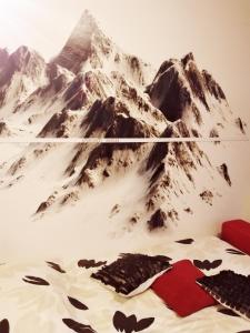 a mountain mural on a wall in a bedroom at Apartman MARLEA in Donovaly