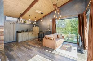 a living room with a couch and a table at Ramiau - su gamta in Kareivonys +14 photos