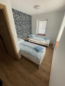 a room with two beds and a window at Apartament JULIA in Głuszyca