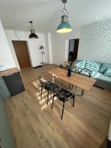 a living room with a table and chairs and a couch at Apartament JULIA in Głuszyca