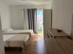 a bedroom with two beds and a desk and a table at La Playa in Adeje +18 photos