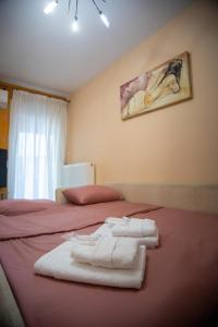 a bedroom with two beds with towels on them at The 5th floor in Florina