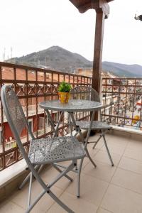 a table and chairs on a balcony with a plant at The 5th floor in Florina