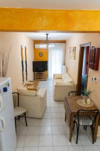 a living room with a couch and a table at The 5th floor in Florina