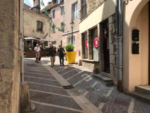 a group of people walking down a street at historique in Clamecy