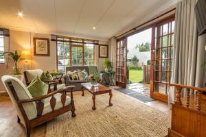 ein Wohnzimmer mit Sofa und Tisch in der Unterkunft Khanyeni in Himeville