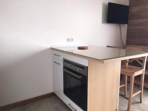 a kitchen with a counter and a black dishwasher at Charming mountain studio in Mont-Saxonnex +1 photo