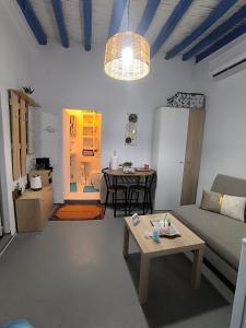 a living room with a couch and a table at Villa fisfiri 1 in Serifos Chora
