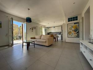 a large living room with a couch and a table at Fortuna Garden House in Imperia