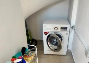 a washer and dryer sitting in a laundry room at Villa Bloom in Achladies