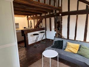 a living room with a blue couch and a table at historique in Clamecy