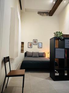 a bedroom with a bed and a table and a chair at Casa Politi in Parma