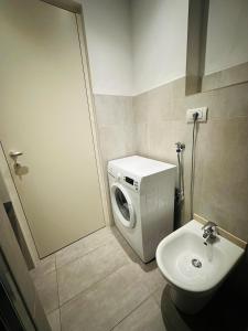 a bathroom with a washing machine and a sink at Casa Politi in Parma +15 photos