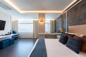 a bedroom with a large bed and a living room at Hotel Il Gabbiano in Bacoli