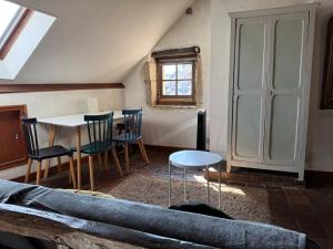 a living room with a table and chairs at historique in Clamecy