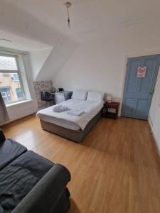 a bedroom with a bed and a blue door at Princess Homestay in Sunderland