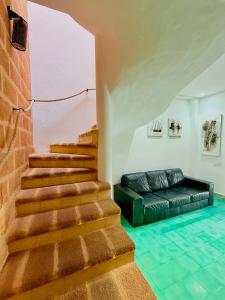a stairway with a couch and a brick wall at Oualidia surflodge in Oualidia