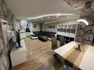 a living room with a dining table and a couch at Apartament Alan in Kłodzko
