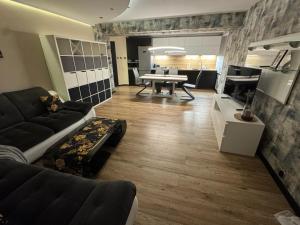 a living room with a couch and a table at Apartament Alan in Kłodzko