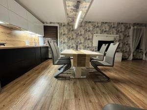 a kitchen and dining room with a table and chairs at Apartament Alan in Kłodzko +3 photos