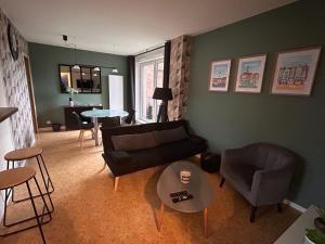 a living room with a couch and a table at Lestandardgravelines in Gravelines