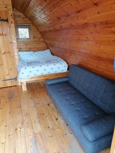 a room with a bed and a couch in a cabin at Castle View Glamping - 2 Cefn in Llandrindod Wells