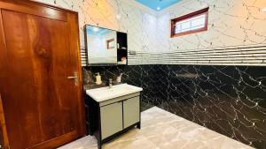 a bathroom with a sink and a mirror at Asmi Villa in Jaffna +25 photos