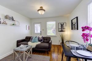 a living room with a couch and a table at Jolly Jefferson Ave Walk to the Best of Midtown in Memphis