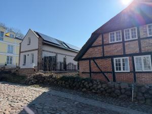 a brick house with a rainbow in the sky at Haus Maria am Meer in Göhren
