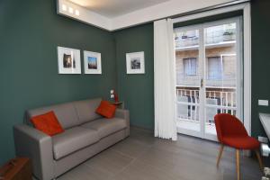 a living room with a couch and a window at Bed In Centro in Naples